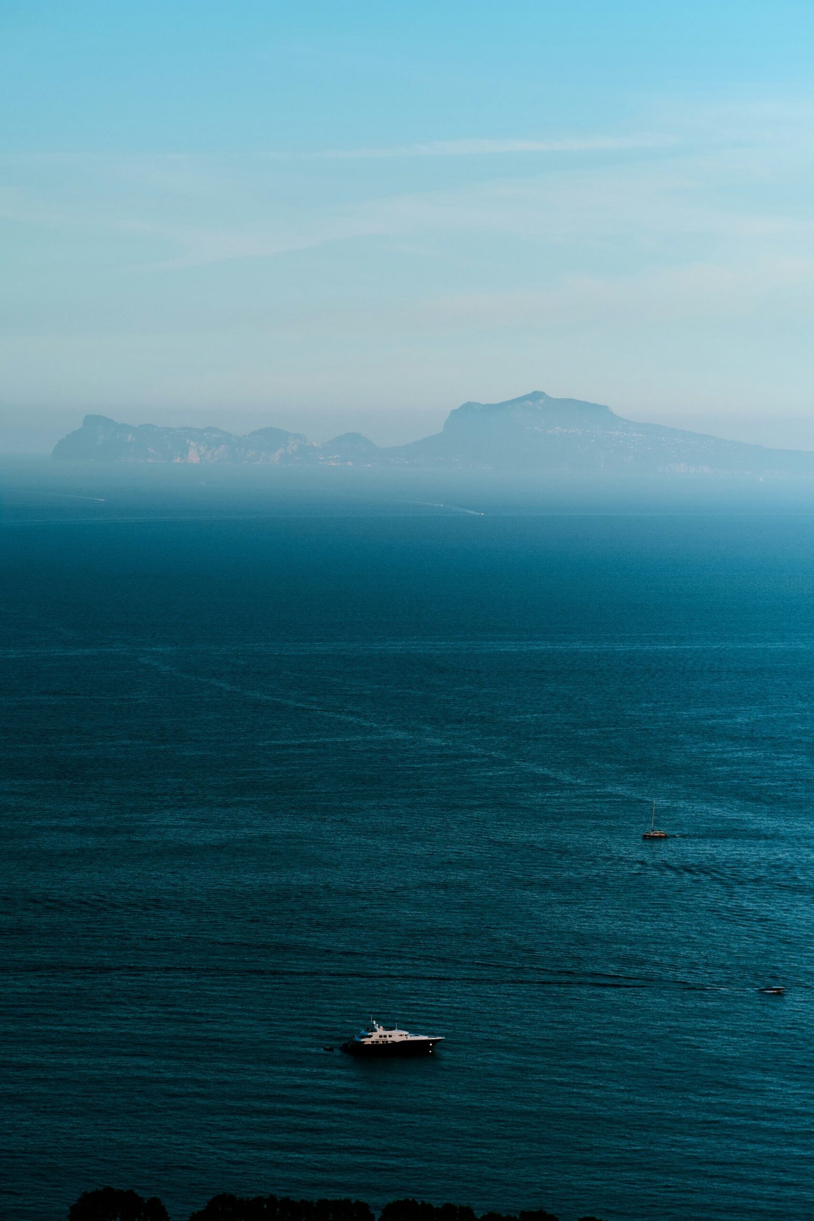 a boat floating in the middle of a large body of water