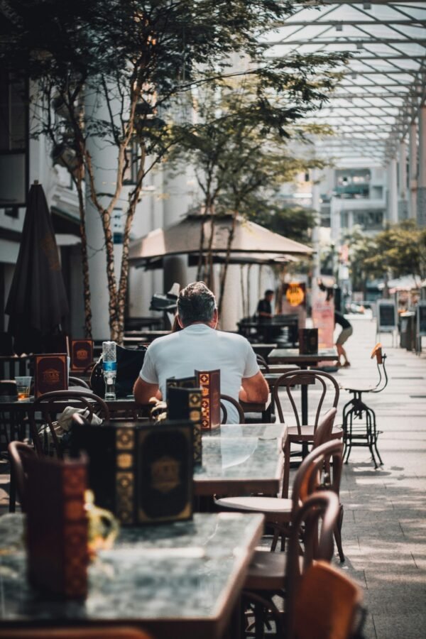 man sitting on chair man sitting on chair near tree