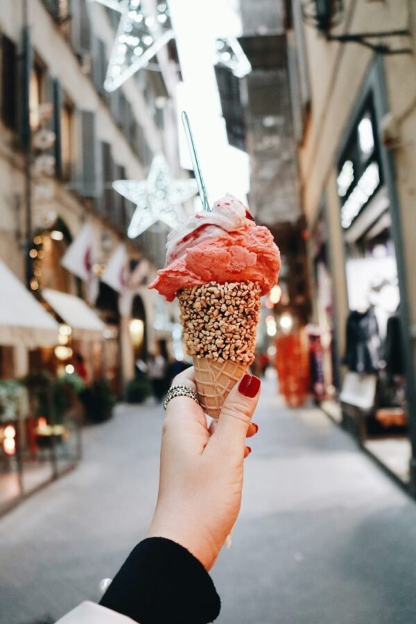 person holding ice cream person holding ice cream