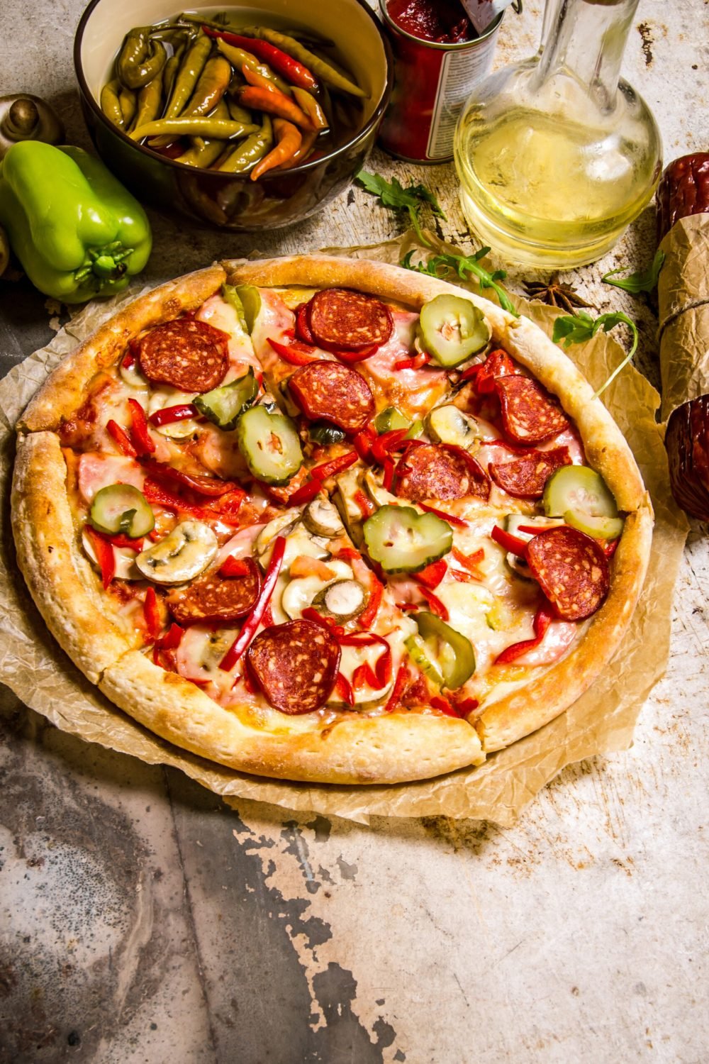 Tasty pizza with pepperoni and tomato sauce. On rustic background. On rustic background.